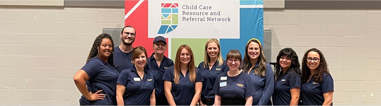 Child Care Answers staff in front of the Child Care Resource and Referral Network sign