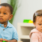 four toddlers in a child care classroom